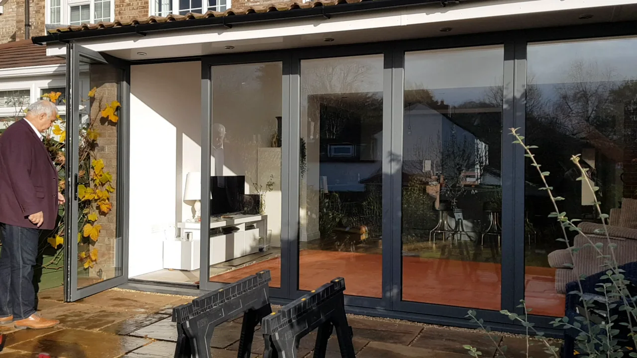 OpenGlide access door open to the patio while the remaining glazed panels stay closed