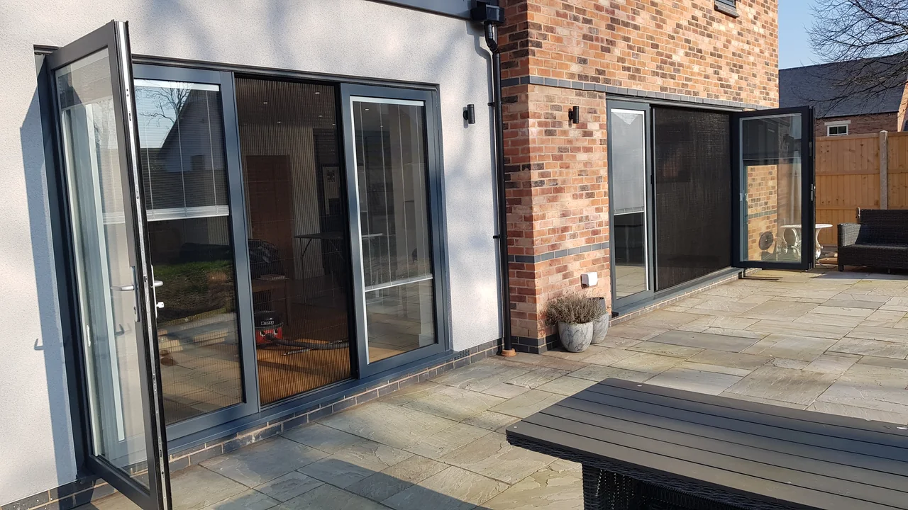 Two garden-facing OpenGlide openings with access doors open and flyscreens in use