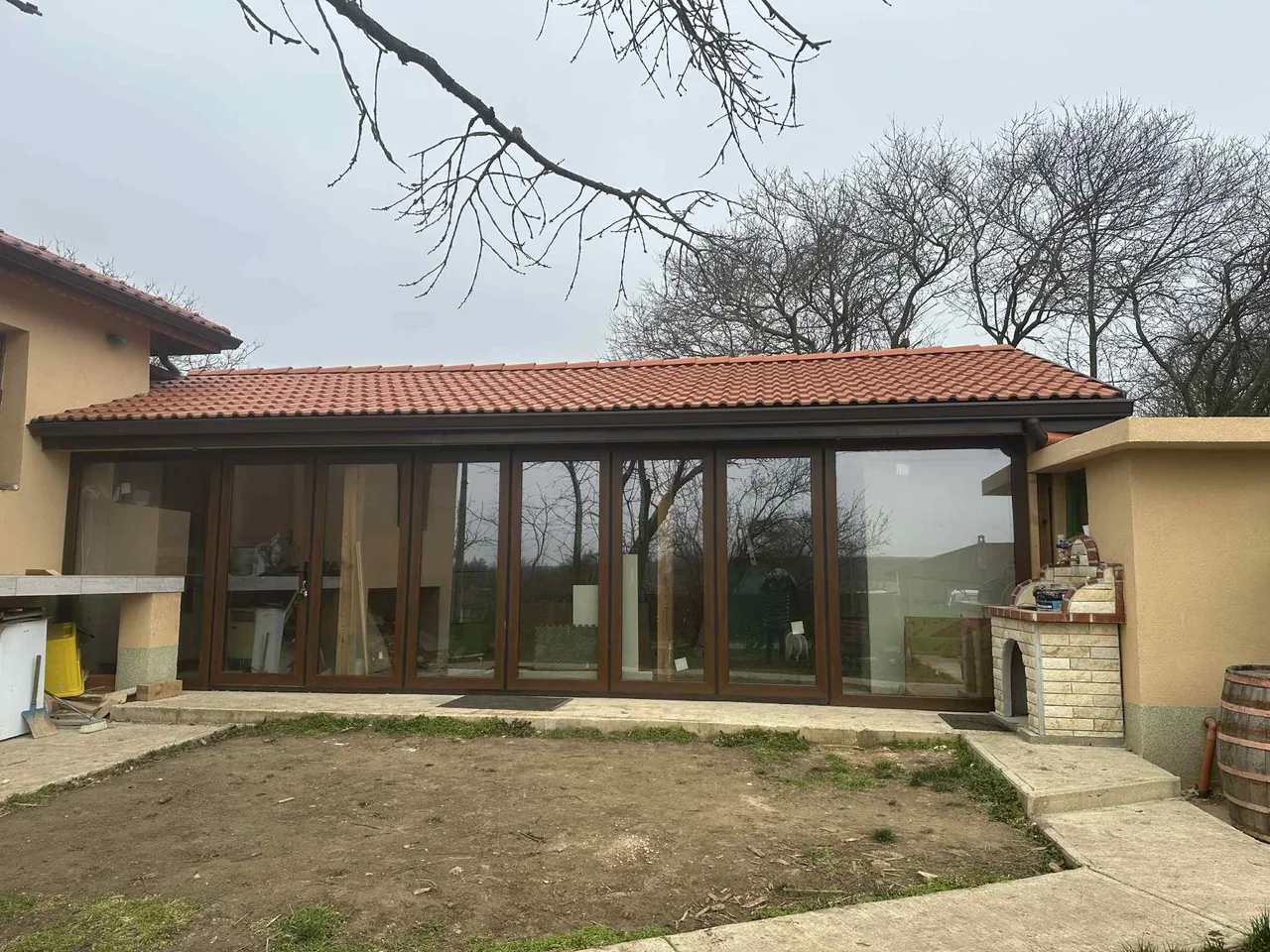 The same wood-effect veranda with the glazed frontage closed.